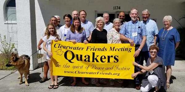 People holding Clearwater Meeting Sign