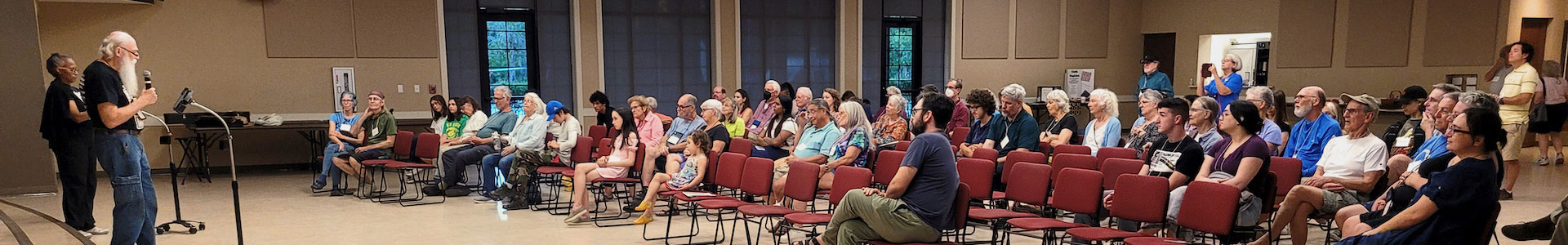 Two people presenting to a group of Quakers