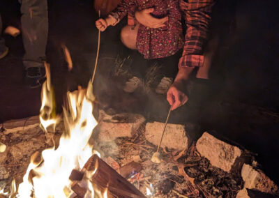 Father and daughter at campfire